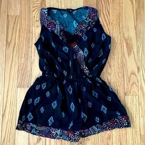 adorable black romper with an aztec kind of design with flowers